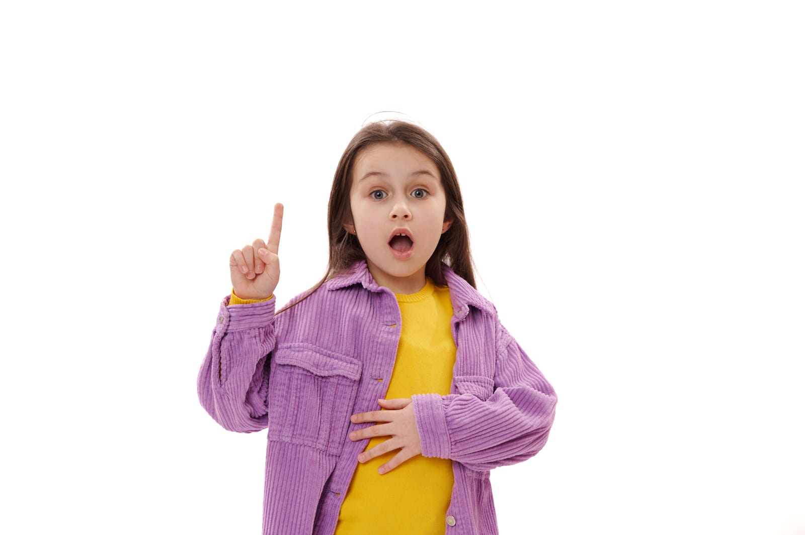 Surprised girl in purple jacket pointing up, symbolizing tips for mastering pediatric board exam question formats and strategies.