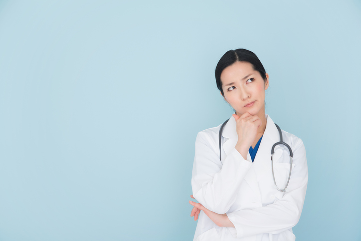 Thoughtful doctor with stethoscope, representing strategies for deciding how many AAP PREP questions to complete for board exam success.